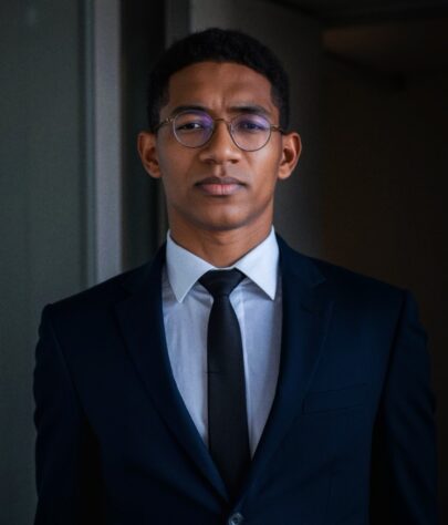 picture_a_man_in_a_navy_blue_suit_and_tie_looking_confidently_at_the_photo_in_cinematic_lighting_in_i6ljxzduam6pobes70y5_3_SnapseedCopy